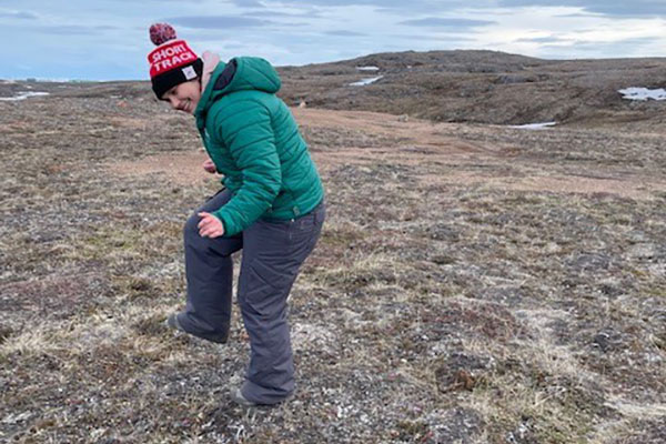 Person dancing joyfully on the tundra.
