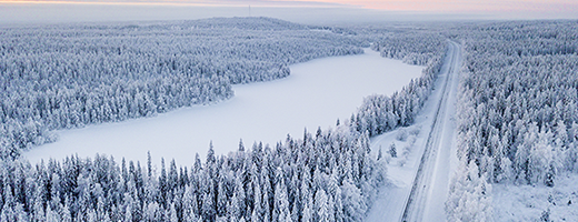 A road running through a snowy landscape.